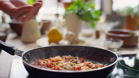 salting food during cooking in frying pan