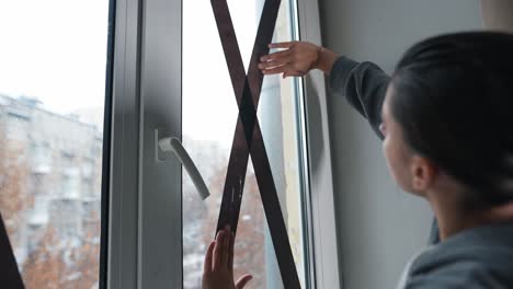 applying protective tape to a window