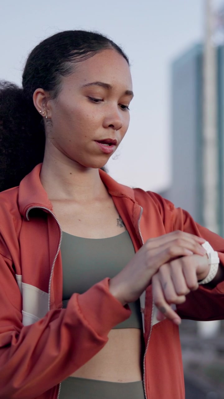 Young Woman Checking Her Smartwatch After Outdoor Workout