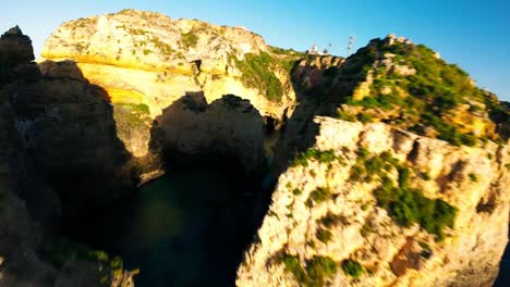 dramatic limestone headland of ponta da piedade in lagos, portugal. fpv shot
