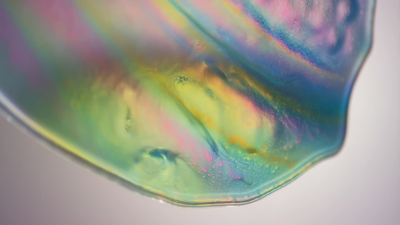 Abstract Close-Up of an Iridescent Soap Bubble Surface with Vibrant Rainbow Colors