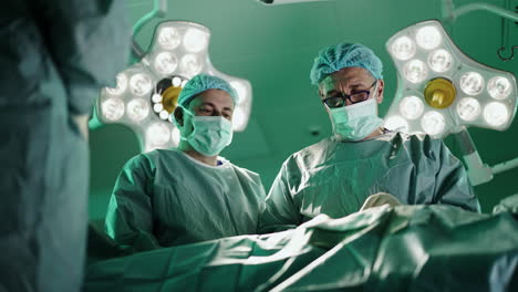 surgical team performing an operation in a hospital operating room
