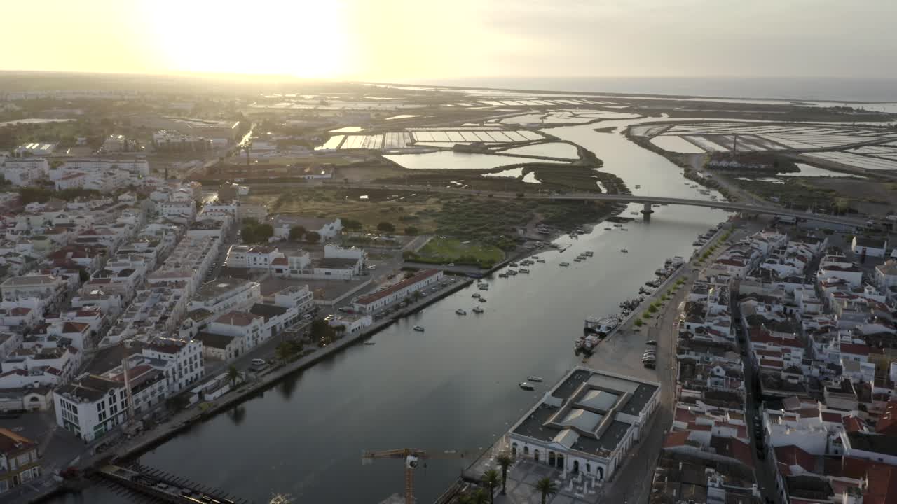 Sunlight bathing the city of Tavira in warm light as we look out towards the surrounding landscape and the sea