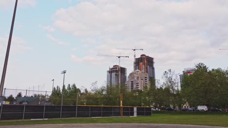 aerial view of a vibrant urban skyline revealing lush green trees, condos and skyscrapers in the city center of surrey, bc