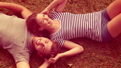 happy cute couple lying together in the park