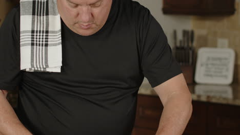 man removing silver skin on ribs he's preparing to bbq