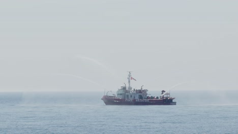 fire rescue boat spraying water into a lake