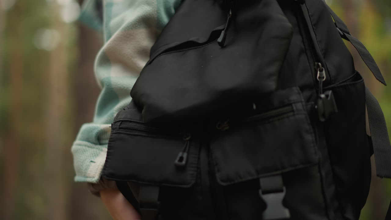 Hiker explores outdoors, Adventure in natural woodland settings, Wanderer discovering nature with reliable pack, Vagabond traverses woodland areas carrying durable backpack on move