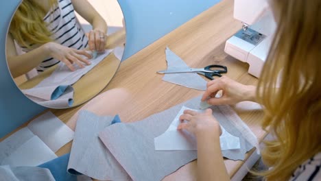 woman sewing a clothing item