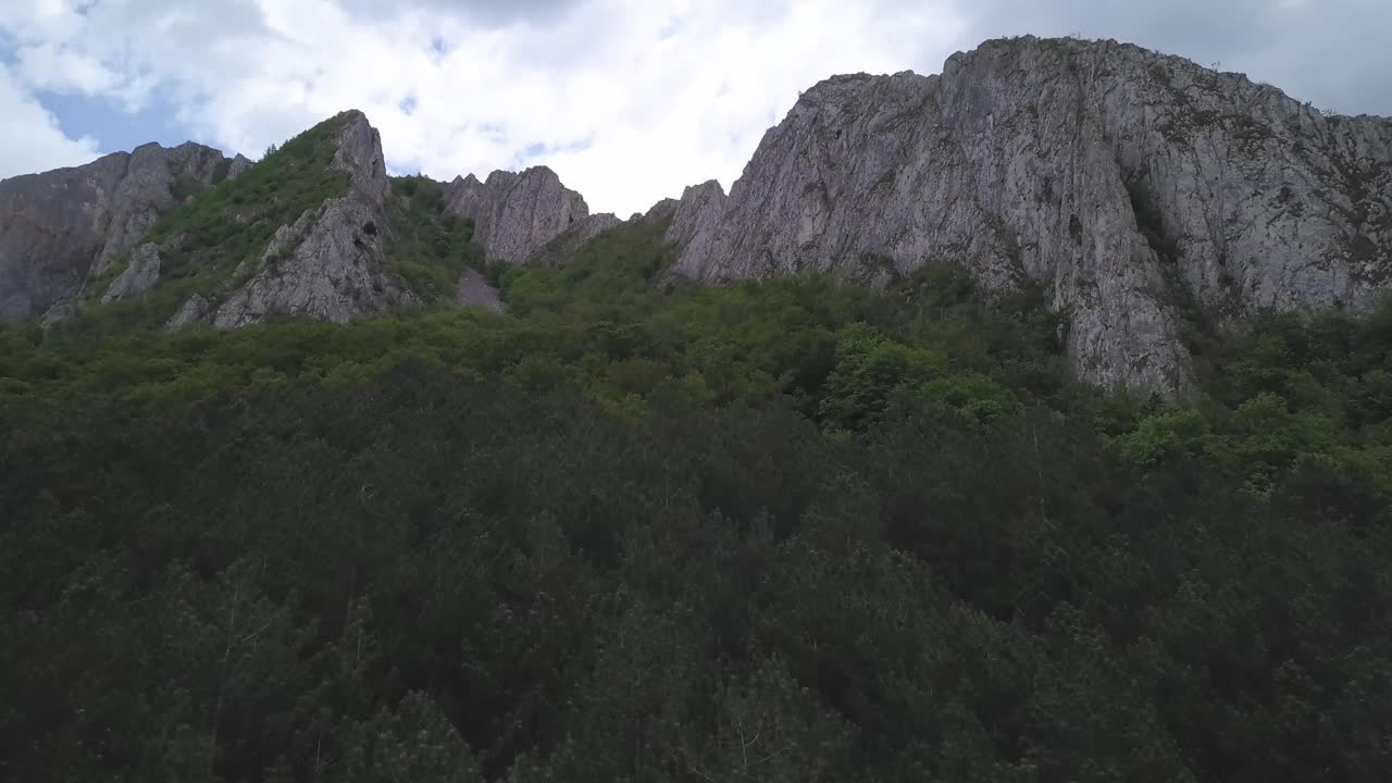 Aerial View Of Rocky Steep Cliffs Overlooking Green Vegetation, Wide Shot