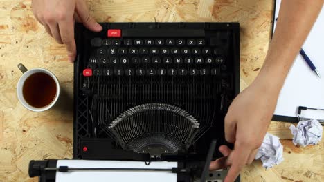 Person Working on a Vintage Typewriter