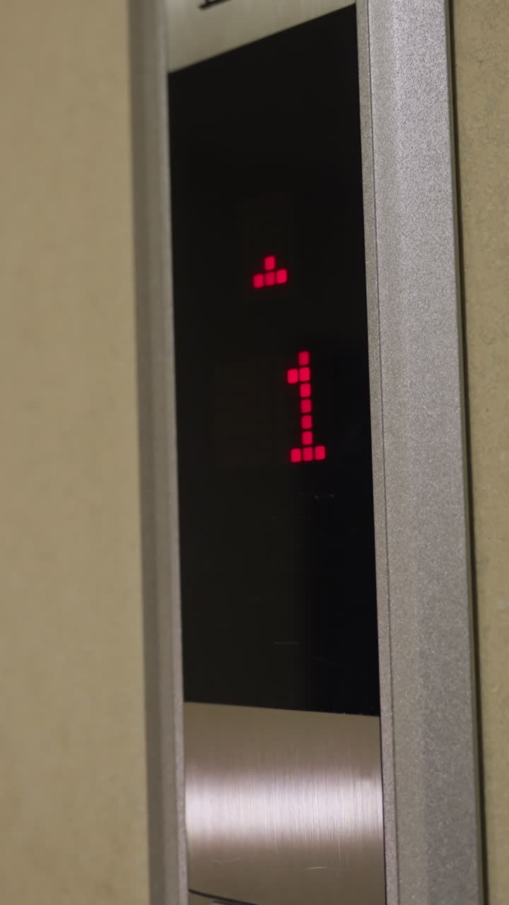 Close-up shot of elevator control panel with upward and downward arrows, illuminated red buttons, modern elevator system, business building, corporate setting, elevator button interface