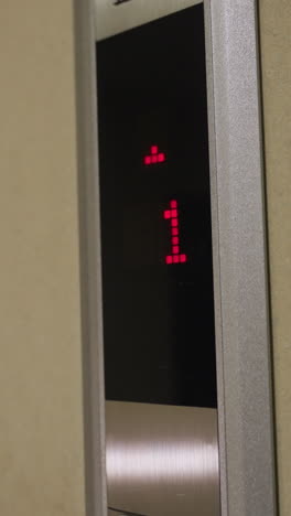 close-up shot of elevator control panel with upward and downward arrows, illuminated red buttons, modern elevator system, business building, corporate setting, elevator button interface