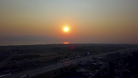 Beautiful-aerial-red-sunset-in-a-smoggy-sky-from-summer-wildfires