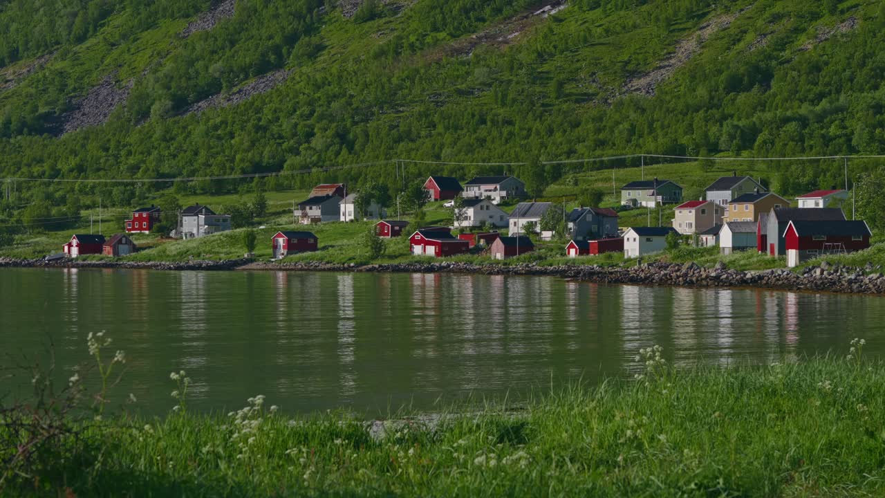 Quiet sunrise over Senja, Norway with colorful houses by the water