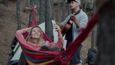 couple relaxing in hammock in the forest