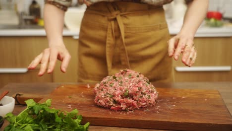 crop woman beating minced meat