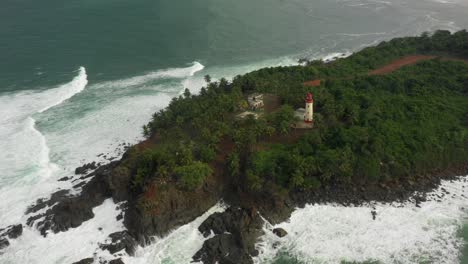 Luftaufnahme-Des-Cape-Three-Points-Leuchtturms-Mit-Großen-Wellen-In-Ghana,-Westafrika