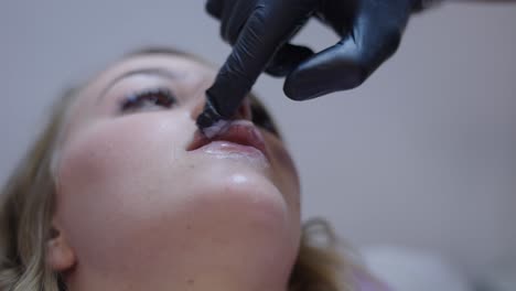 application of anesthetic cream to lips before cosmetic procedure