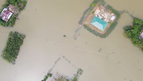 houses in the village on a flooded landscape in bangladesh, south asia. aerial topdown shot