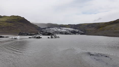 Aerial-View-of-Glacier,-Volcanic-Hills-and-Glacial-Lake-in-Landscape-of-Iceland