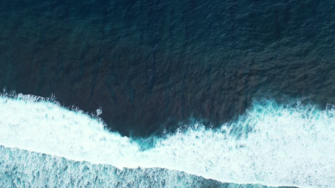 Aerial of the deep depths and contrasting colours of the ocean off the coast of Australia