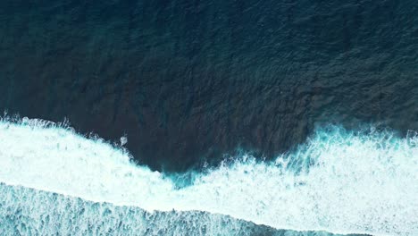 aerial of the deep depths and contrasting colours of the ocean off the coast of australia