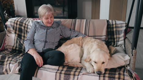 senior woman with golden retriever on a swing