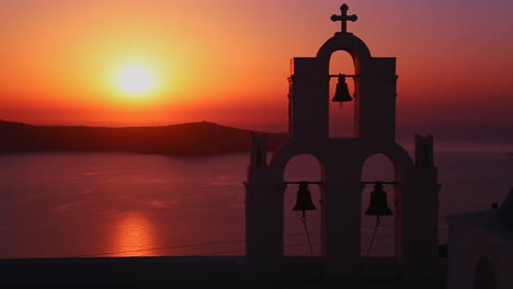 an amazing and beautiful sunset behind a greek orthodox church on the greek island of santorini 2