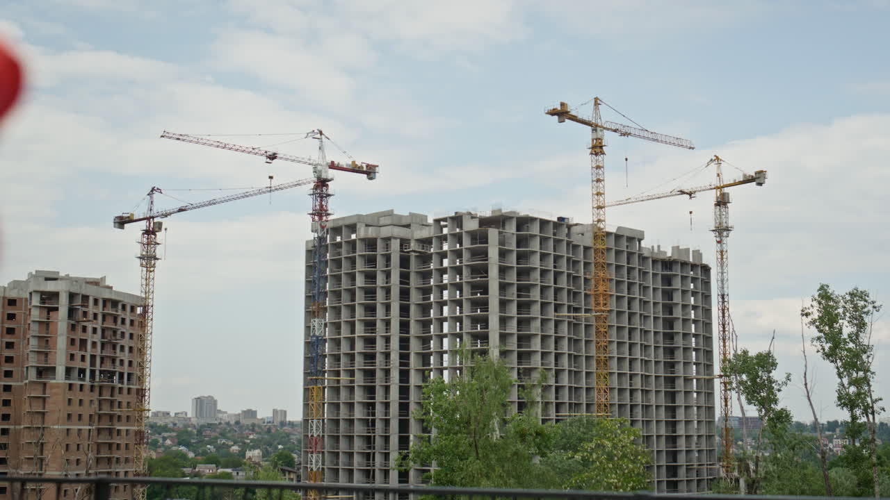 Smiling architects watching construction urban area holding project plan closeup