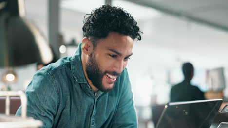 excited man working on laptop in office