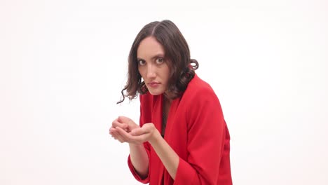 woman counting or holding coins and looking at the viewer