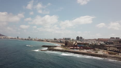 Panoramic-aerial-shot-of-Las-Canteras-beach-in-the-city-of-Las-Palmas-and-spotting-the-Alfredo-Kraus-auditorium