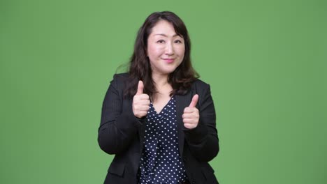 mature beautiful asian businesswoman giving thumbs up