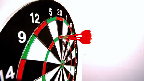 Dart-hitting-the-dart-board-between-two-other-darts-side-view