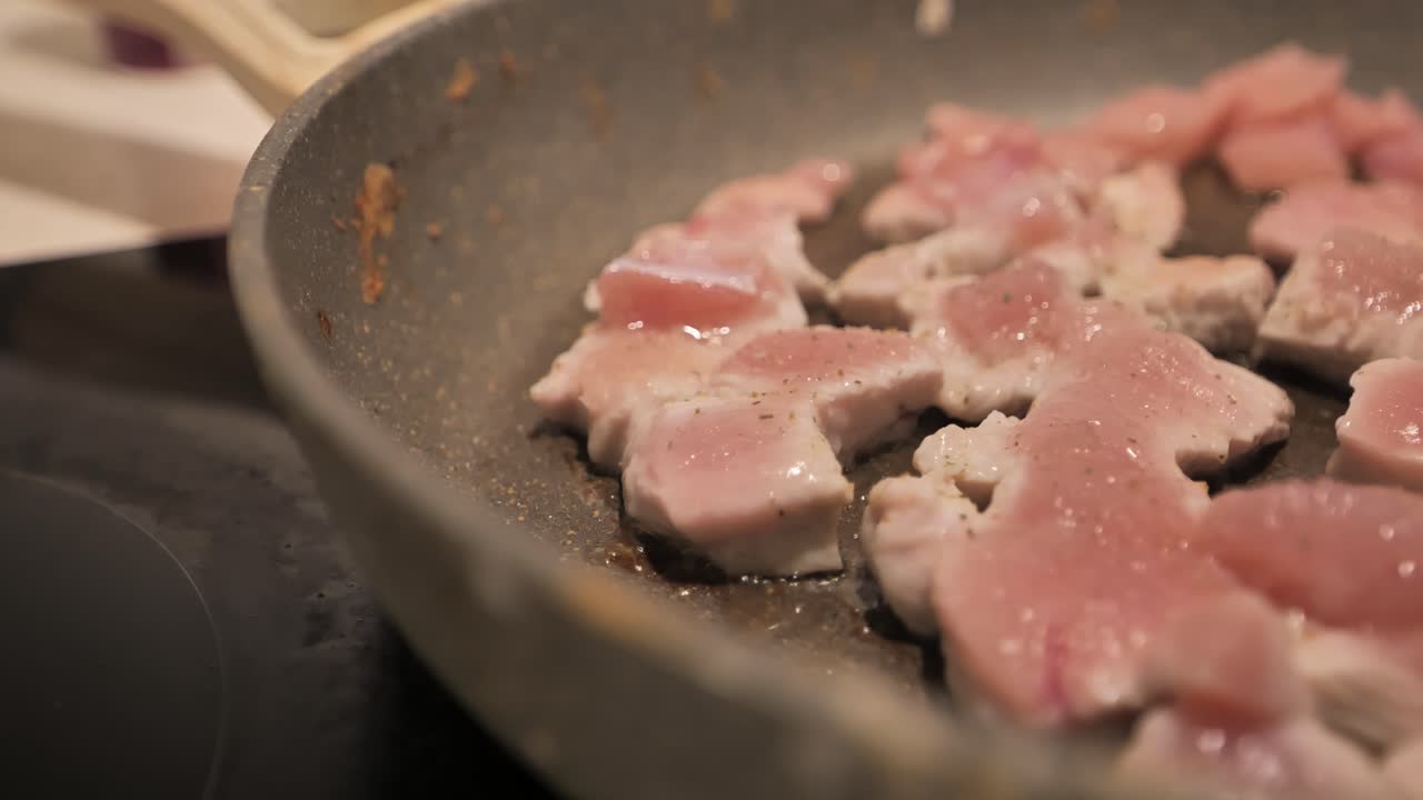 Handheld camera captures the artistic frying of fillet with focus on the pan.
