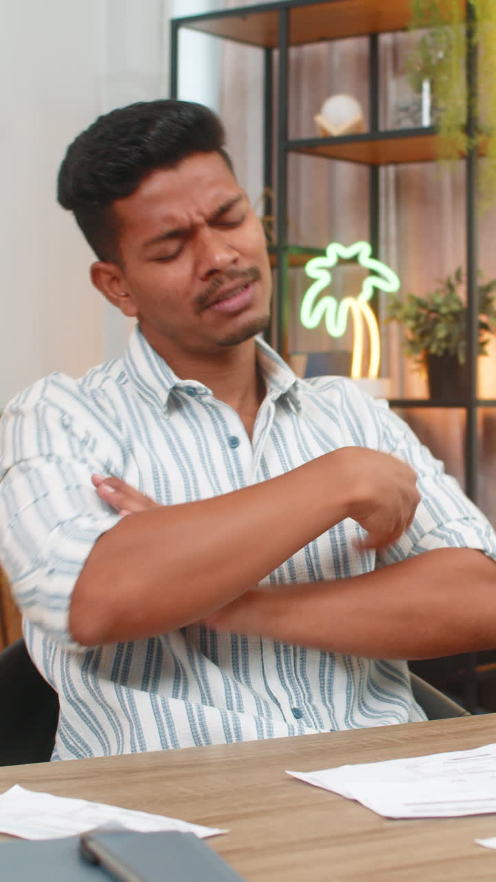 Indian man angry about receipt error throws papers aside breathes deep plans fix and calm focus mood