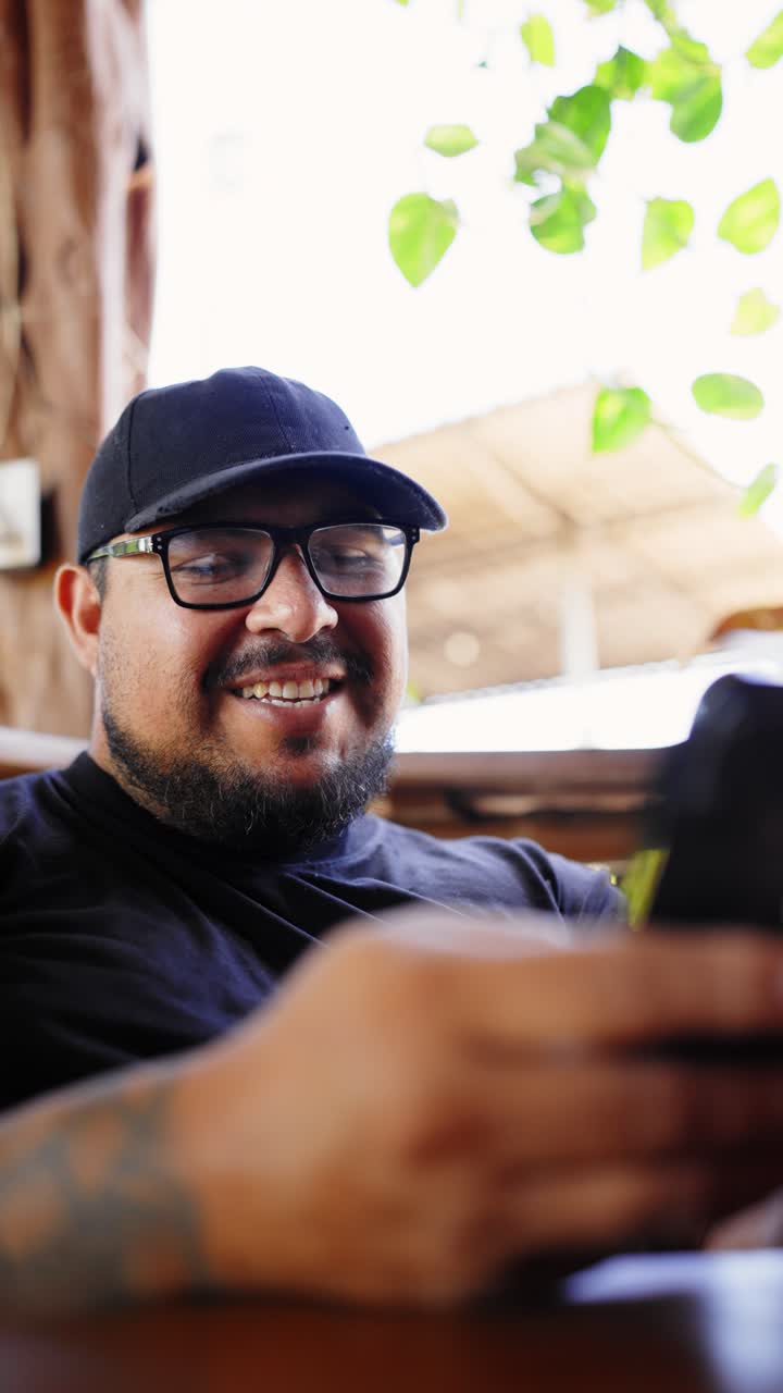 Happy Man in Cap and Glasses Smiling Outdoors