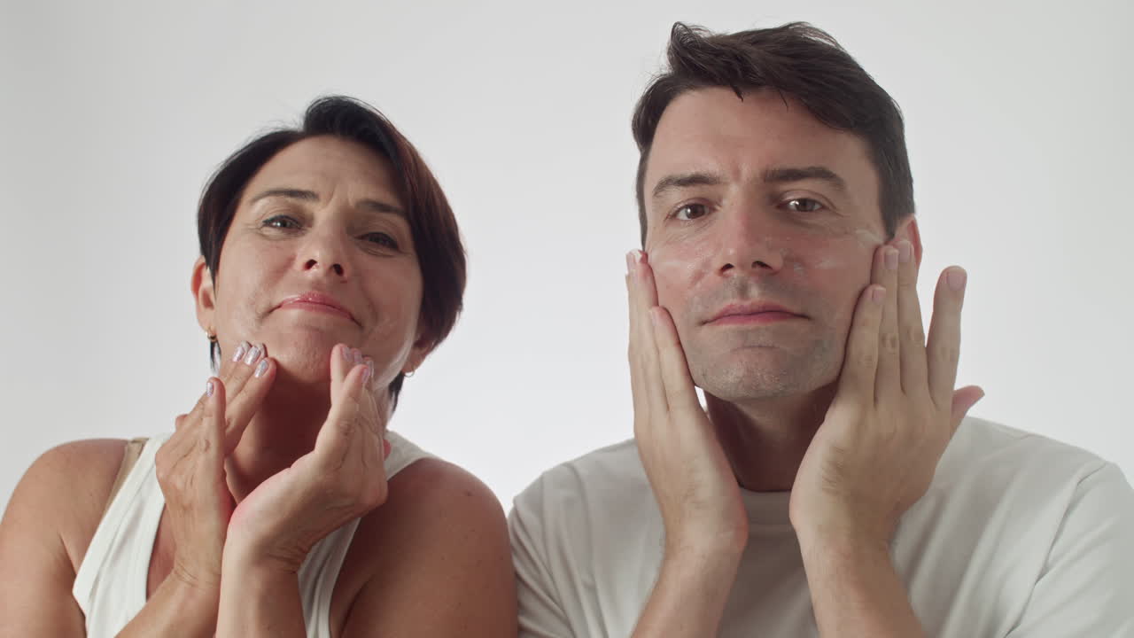 Caucasian Couple Applying Facial Cream