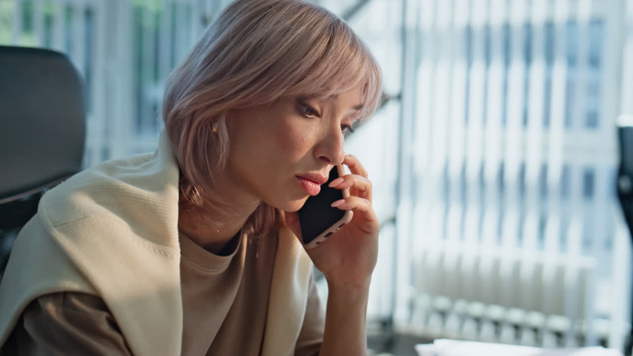 Telesales manager making call modern workplace closeup. Woman talking remotely