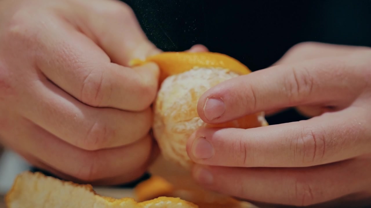 Slow motion peeling citrus symbolizing family care, healthy nutrition