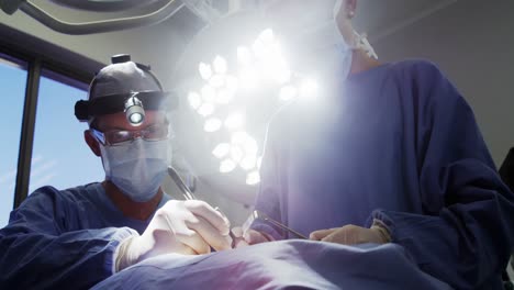 surgeons performing operation in operation room