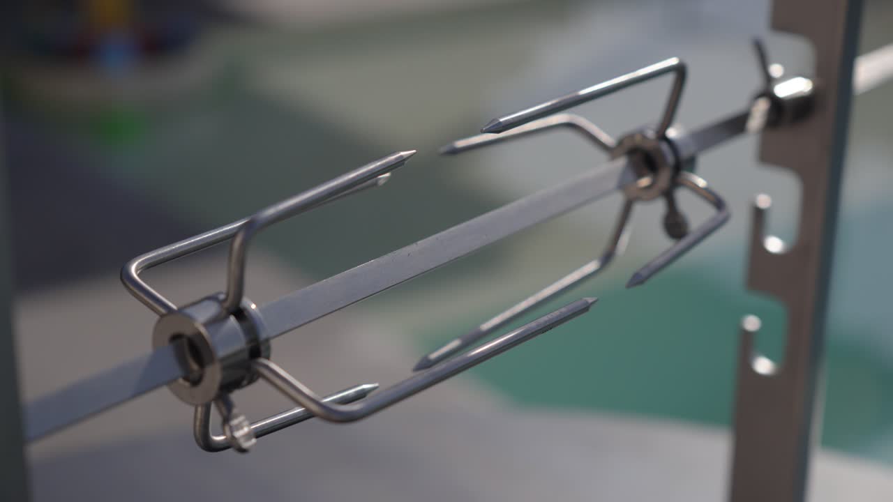 close-up shot of a metal kebab skewers inside of a bbq ready to use