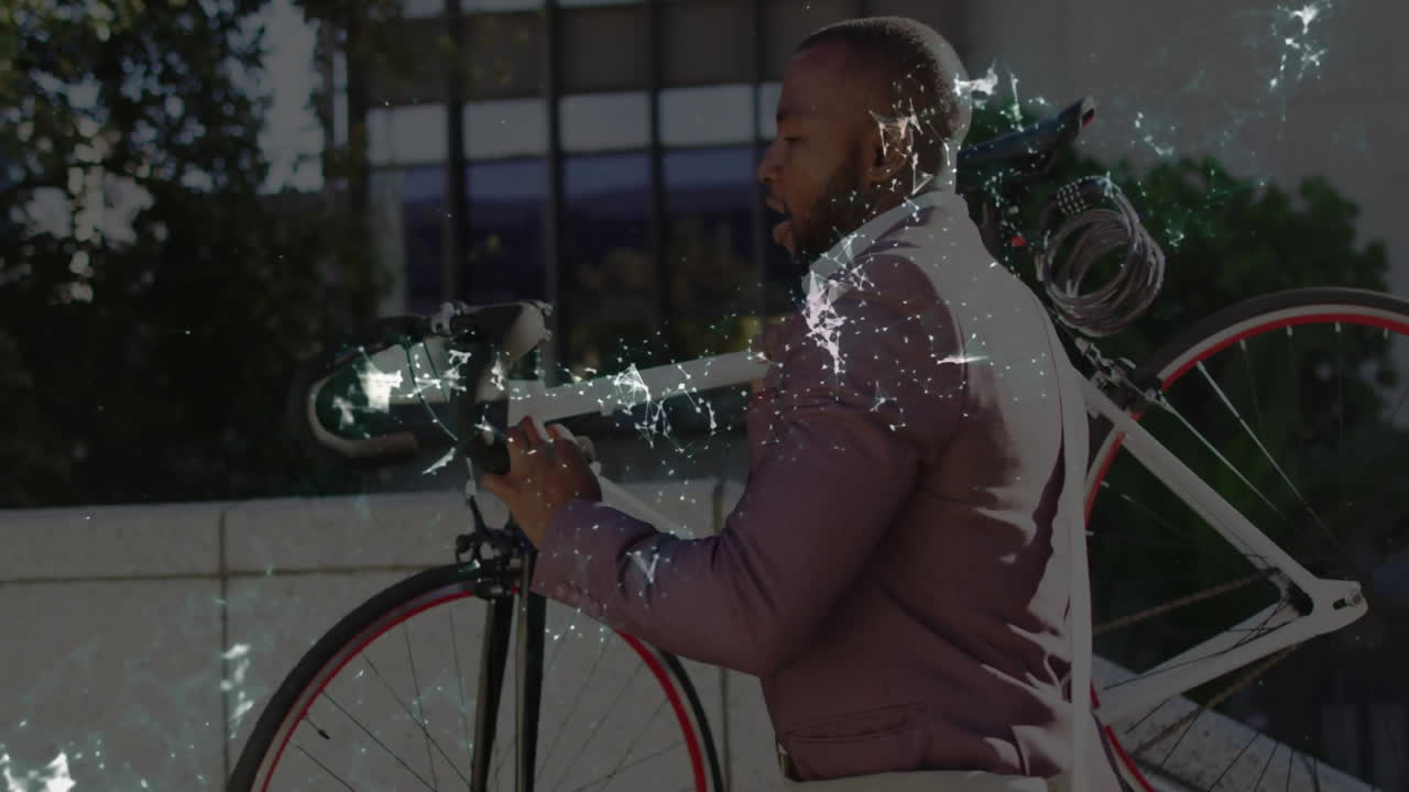 Business professional walking carrying bicycle past office building, showing crackle light effects