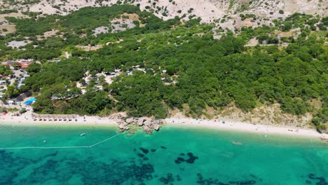 campsite at campig skrila, krk island, stara baska croatia, aerial view of the mountains and coast with boats, beaches and adriatic sea. the seaside rv campmobiles on a summer beautiful coastline