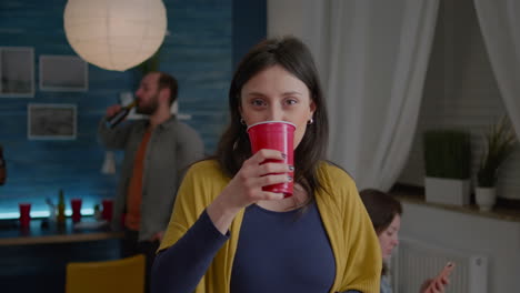 Portrait-of-attractive-woman-drinking-beer-during-celebration-wekeend