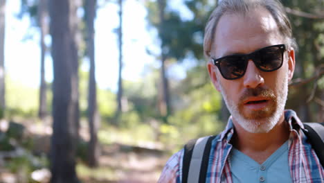 tired hiker standing with backpack