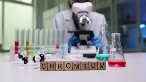 scientist in a laboratory with chromium element blocks and lab equipment