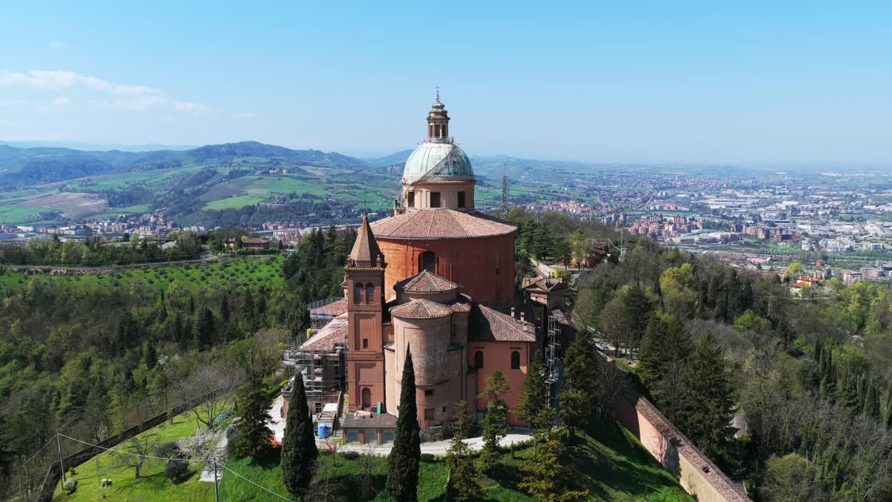 Sanctuary of Madonna di San Luca, perched on hill overlooking Bologna, Italy. Aerial drone orbiting