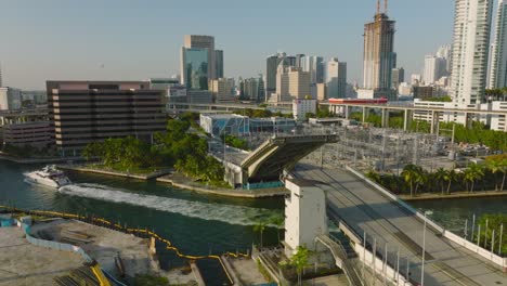 closing of drawbridge after boat passes. movable road bridge over river in modern city at golden hour. miami, usa